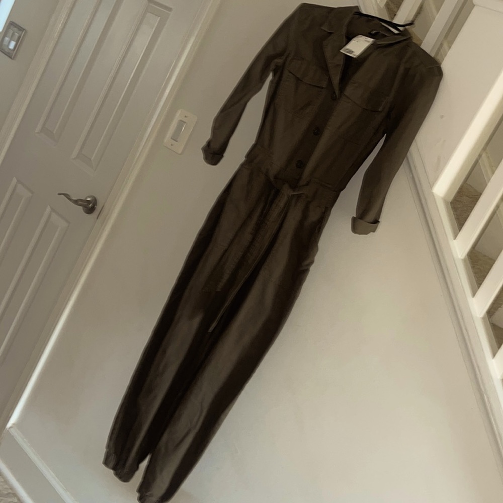 Army green jumpsuit. Never worn with tags. Quarter sleeve. Cinched ankles